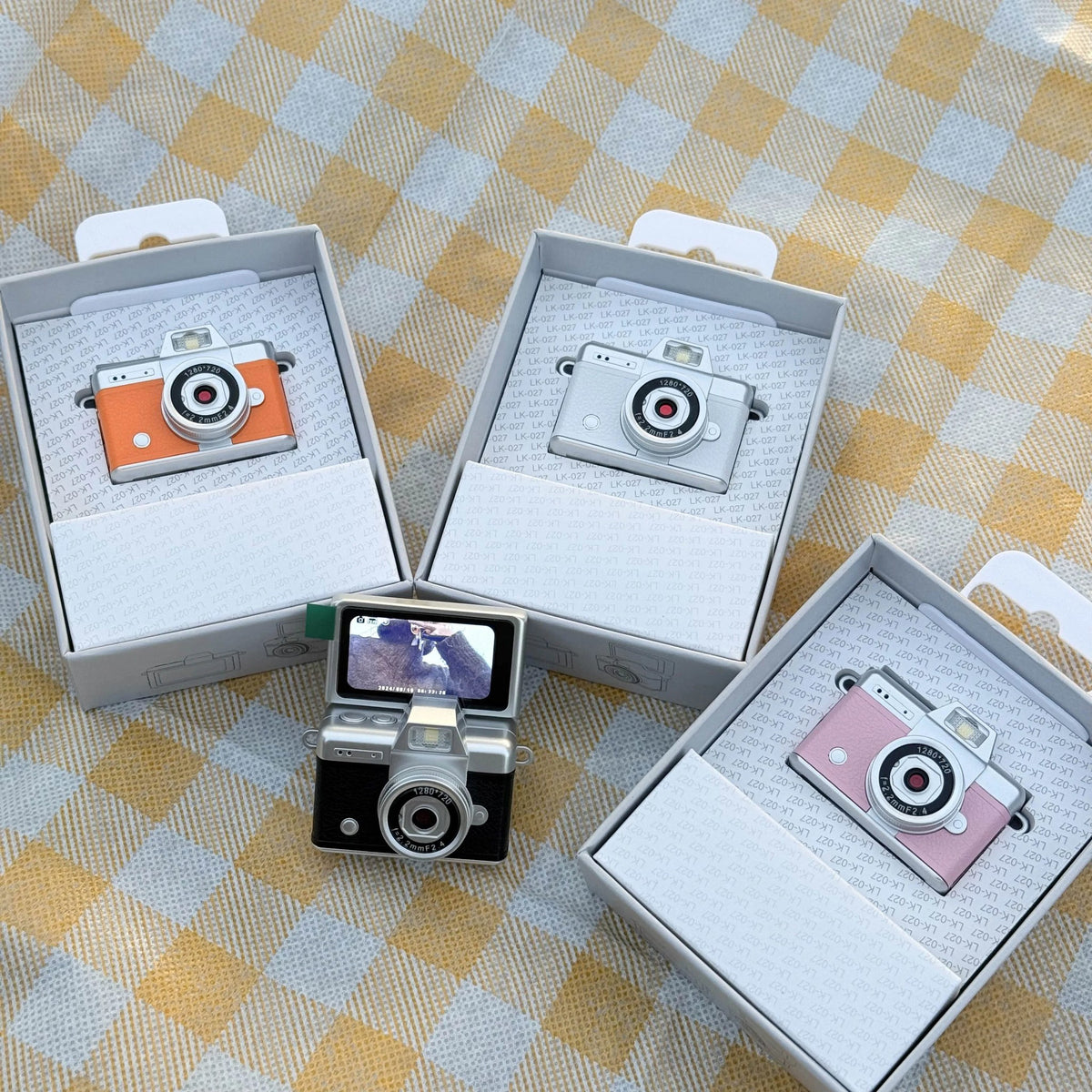 Flip Digicams in orange, silver, black and pink with their gift boxes
